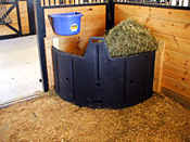 horse hay feeder in a horse stall