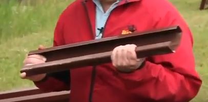 Brown feed bunk connector held by rancher
