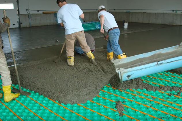 pouring cement over radiant floor heating panel insulation