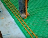 installing pex tubing into the floor insulation panel