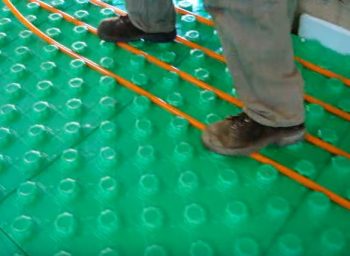 setting the tubing into the floor insulation panels