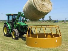loading hay into cattle feeder