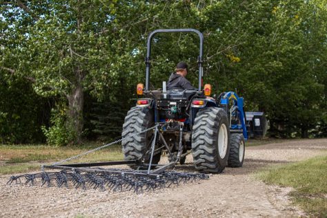 tractor pulling a driveway harrow