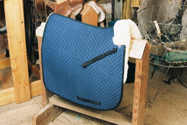 full length sheepskin saddle pad with blue quilting and a partial lining