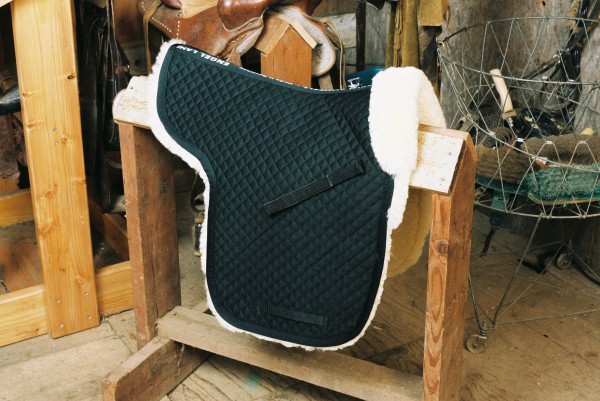 black sheepskin saddle pad with a pommel roll