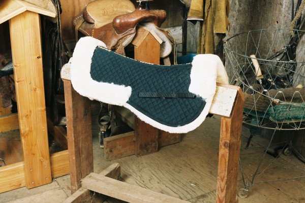 half sheepskin saddle pad with black quilting, pommel and cantle rolls