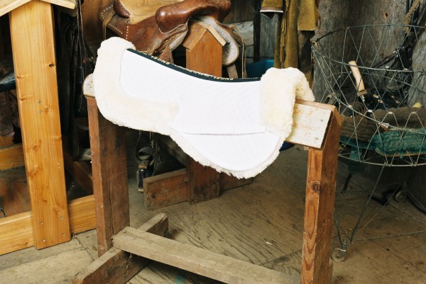 white sheepskin saddle pad with pommel and cantle rolls