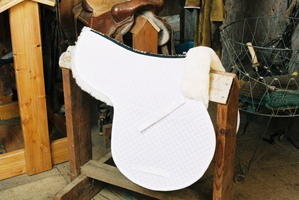 saddle pad with white quilting and partially lined sheepskin