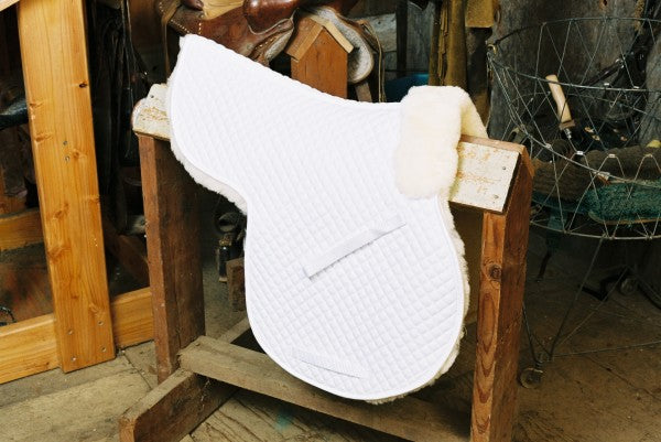 white quilting on a contoured sheepskin saddle pad