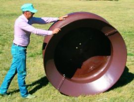 man rolling hay feeder