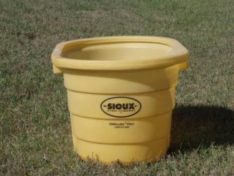 end view of round end poly stock tank in a field