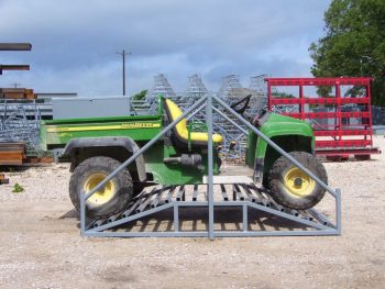 side view of atv crossing the cattle grid