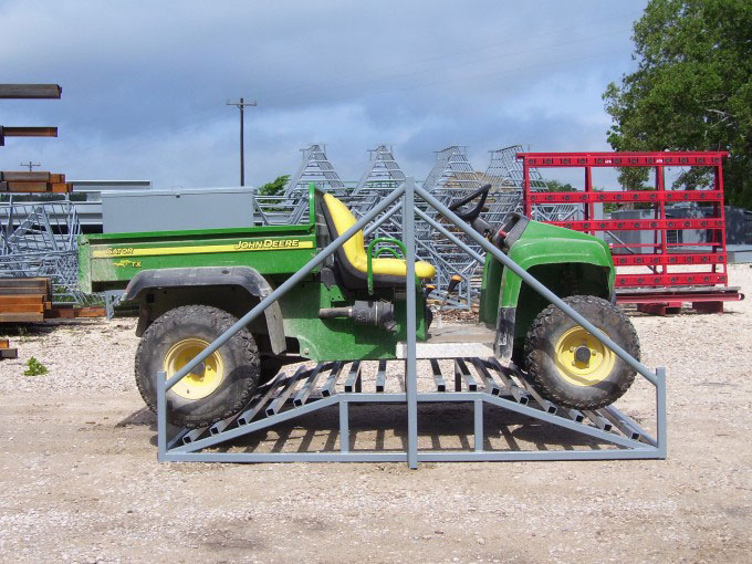 An ATV resting on a cattle guard crossing