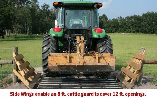 tractor crossing a concrete cattle guard with mower