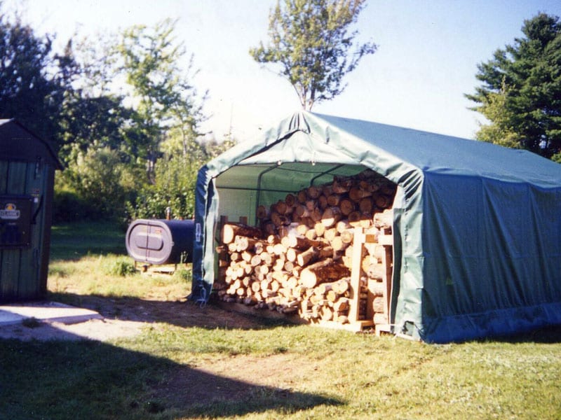 portable shed outside and filled with wood