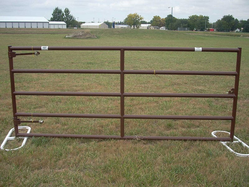 farm gate in a field with hinges