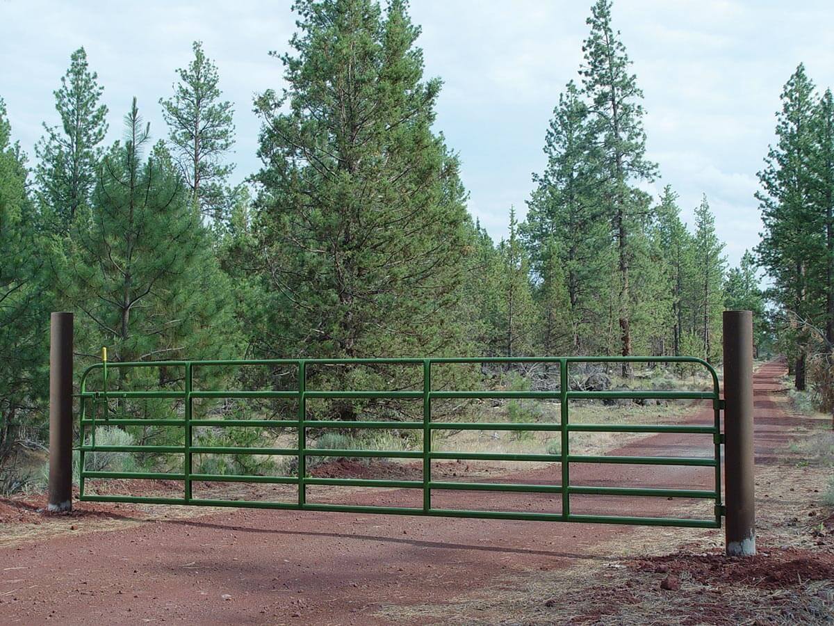 long green ranch gate across a driveway