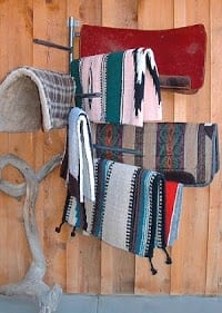 saddle blankets on a 10 arm saddle pad rack