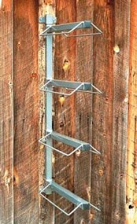 saddle rack mounted to the wall to hold four saddles