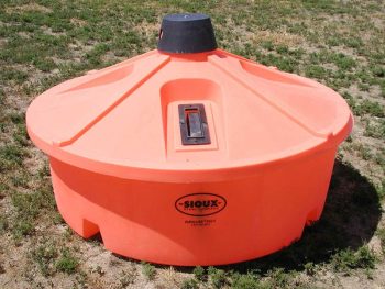 lick tank mineral feeder in a pasture