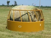 large bale hay feeder in the pasture