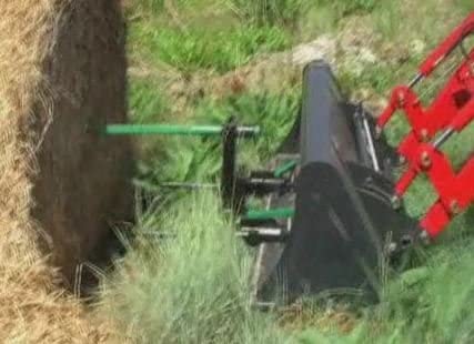 hay bale spear lifting hay
