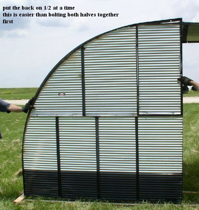 the back section of the metal shelter is attached to the building