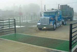 large truck approaching a cattle guard crossing