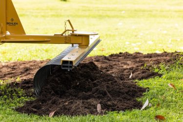 Implement rake pushing dirt efficiently