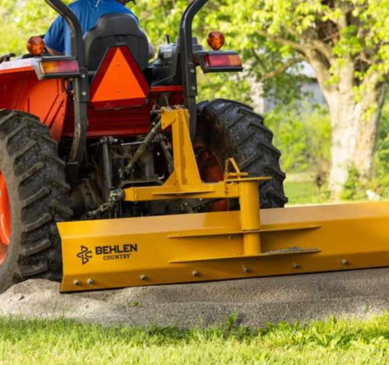 Grader blade in use leveling dirt