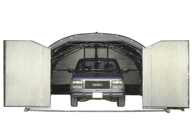 a truck inside the open doors of the metal shelter